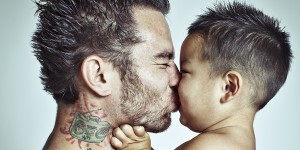 A father kisses his son. © Marilyn Nieves/iStockphoto.com