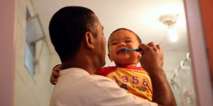 Marcio brushes his young son's teeth in a still from "MenCare Short: Brazil."