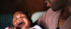 Andrew holds his newborn in a still from "MenCare Short: South Africa."