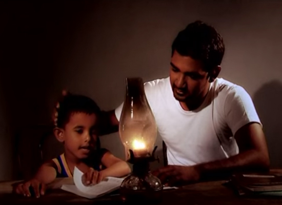 d together by candlelight in still from World Vision Lanka's MenCare TV spot.