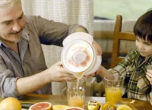 Father and child make orange juice together in still from MenCare Bulgaria's film "To Be A Dad."