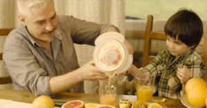 Father and child make orange juice together in still from MenCare Bulgaria's film "To Be A Dad."