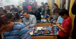 Fathers and children participate in a workshop with seashells in school in Tsarevo, Bulgaria.