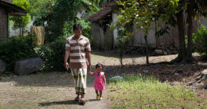 Father and daughter in Indonesia walk together holding hands. Credit: Paul Kadarisman.