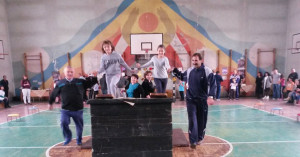 Fathers and children in a gymnasium.