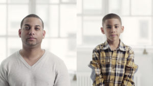 A man and a child look at the camera in a still from "America's Dads."