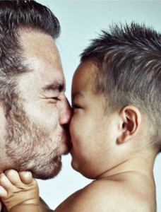 A father kisses his son. © Marilyn Nieves/iStockphoto.com
