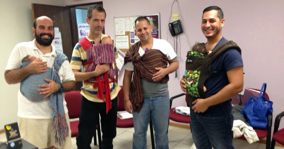 Participants in SePARE fathers’ group learn about different ways to carry their babies during their monthly meeting.
