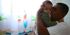 Marcio holds his young son in a still from "MenCare Short: Brazil."
