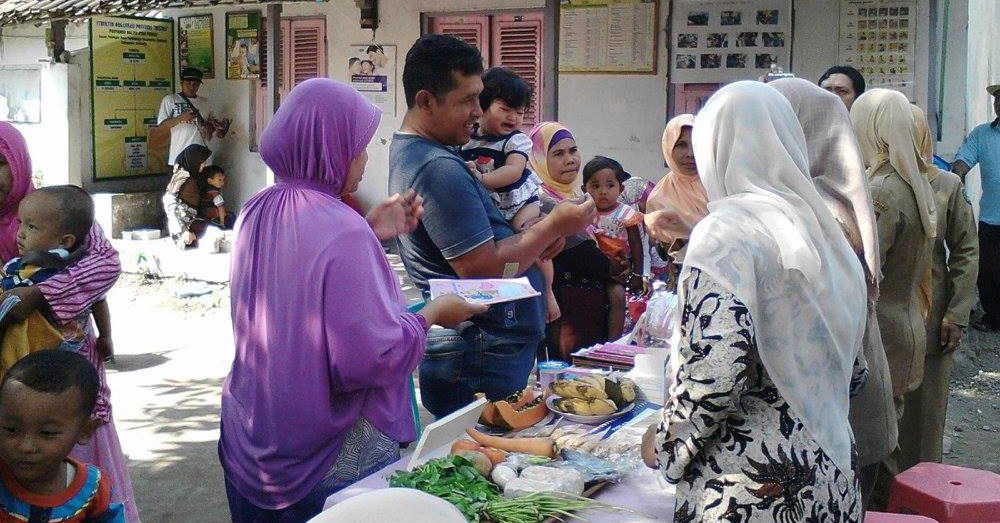 Families at a health center in Tambak Rejo, East Java, Indonesia.