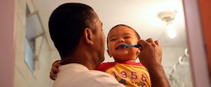 Marcio brushes his young son's teeth in a still from "MenCare Short: Brazil."