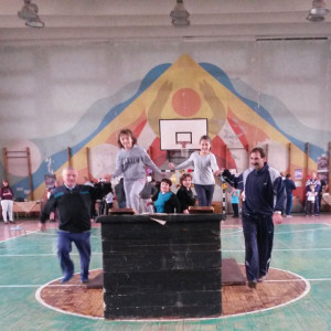 Fathers and children in a gymnasium.