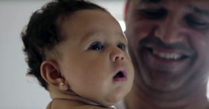 Still of a father and baby from the film "Father Is Not A Visitor."