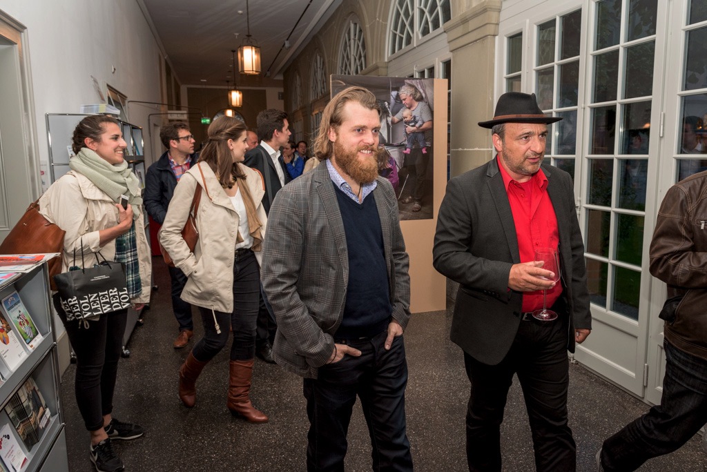 Visitors at the vernissage of the Swiss Dads photo exhibition by Johan Bävman.