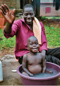 Father bathing son