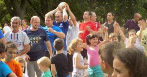 Fathers and children play outside.