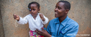 A man and his daughter in Rwanda. Photo by Perttu Saralampi.