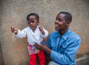 A man and his daughter in Rwanda. Photo by Perttu Saralampi.