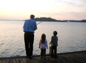 Father and children fishing in Sweden.